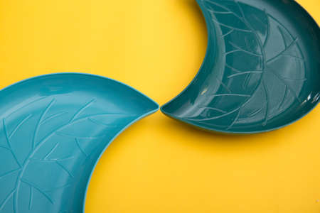 Two empty plates on yellow background. Top view, flat layの写真素材