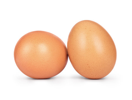 Two chicken eggs close-up isolated on white background
