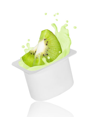 Kiwi slices falling into yogurt splash in plastic packing, isolated on white backgroundの写真素材