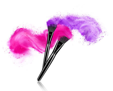 Make up brushes with powder splashes isolated on white backgroundの写真素材