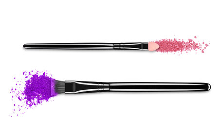 Crushed eyeshadows with brushes close-up, isolated on white backgroundの写真素材
