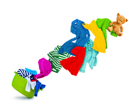 Bright colorful clothes flying out from wash bowl, isolated on white backgroundの写真素材