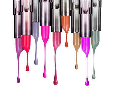 Melting colored lipsticks with falling drops down close-up, isolated on white backgroundの写真素材