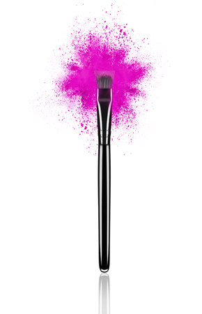 Pink make up brush with powder splash close-up, isolated on white backgroundの写真素材