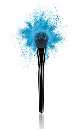 Blue make up brush with powder splash close-up, isolated on white backgroundの写真素材