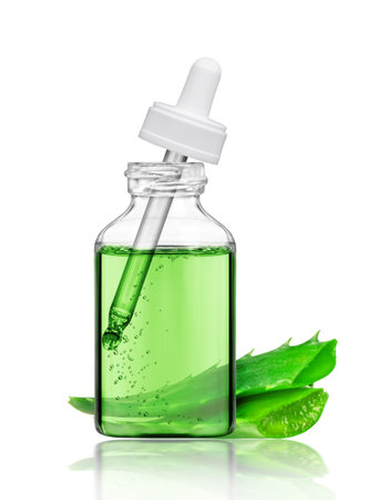Cosmetic bottle with aloe vera stems, isolated on white backgroundの写真素材