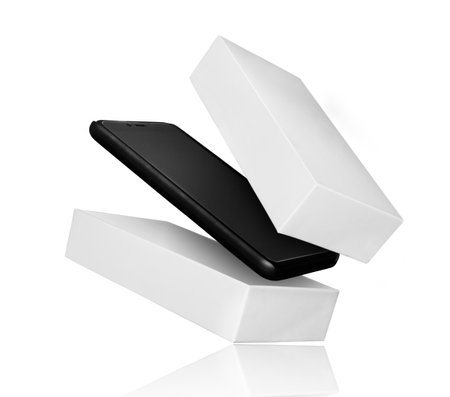 Smartphone flies out of the package, isolated on white backgroundの写真素材