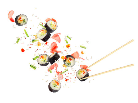 Pieces of sushi fly in the air on a white backgroundの写真素材