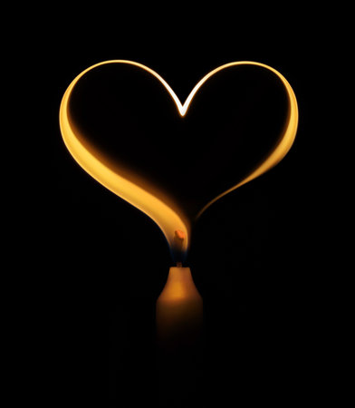 Candle flame in the form of a heartの写真素材