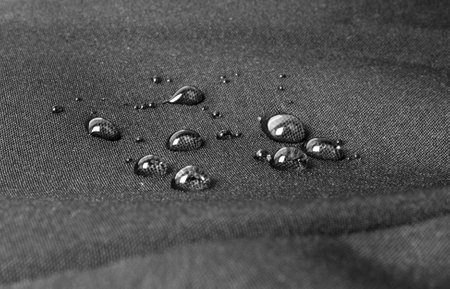 Dark waterproof fabric with waterdrops close upの写真素材
