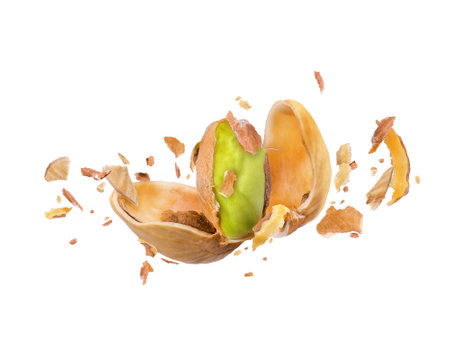 Cracked pistachio frozen in the air on a white backgroundの写真素材