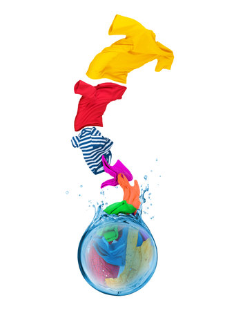 Colorful t-shirts fly out from splashes of water on a white backgroundの写真素材