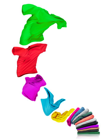 T-shirt flies out of a pile with clothes isolated on white backgroundの写真素材