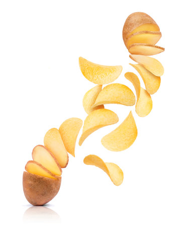 Potato slices turn into chips. Conceptual image on white backgroundの写真素材