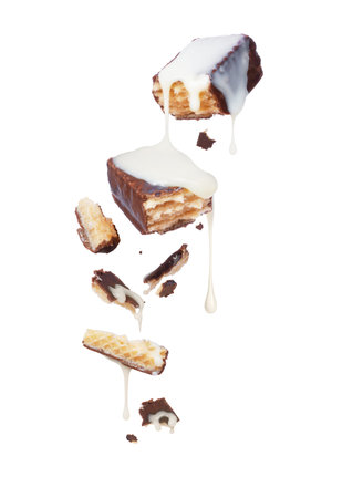 Waffle chocolate bar is poured over condensed milk, isolated on white backgroundの写真素材