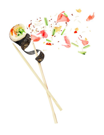 Unfolded sushi roll is sandwiched between of wooden chopsticks, isolated on white backgroundの写真素材
