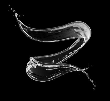 Splashes of water in a swirling shape on black backgroundの写真素材
