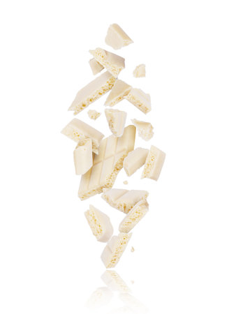 Broken porous white chocolate fall down on white backgroundの写真素材