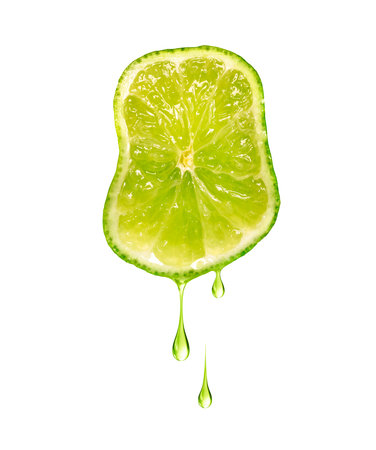 Drops of juice dripping from sliced lime isolated on a white backgroundの写真素材