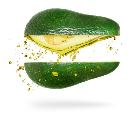 Chopped avocado with splashes of juice, isolated on white backgroundの写真素材