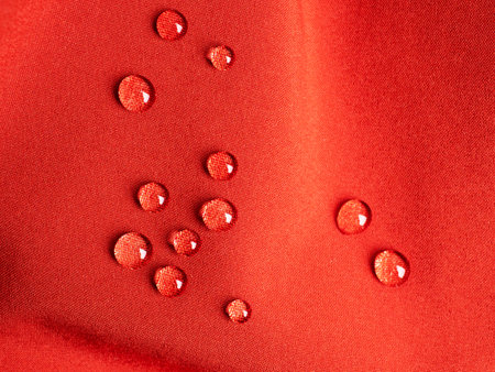 Raindrops on red sports waterproof fabricの写真素材