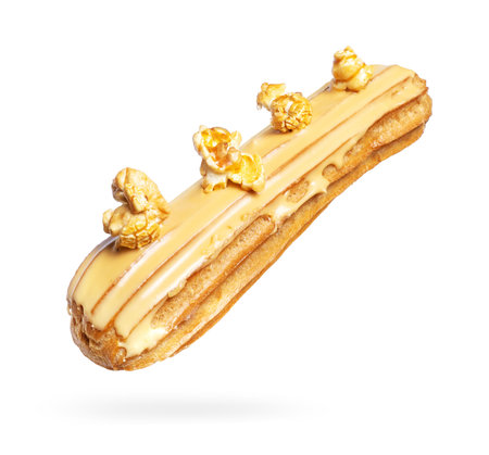 Delicious eclair with popcorn close-up on a white background