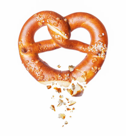Freshly baked pretzel broken in the air on a white backgroundの写真素材