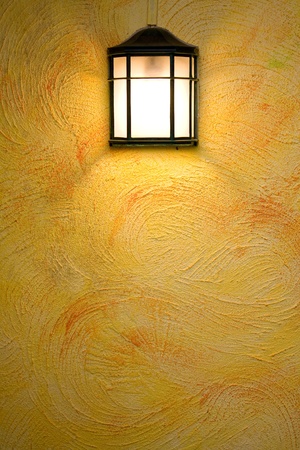 Classic dark brown lamp on yellow abstract wallの写真素材