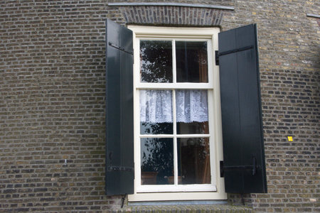 Black shutters on the white windowの写真素材