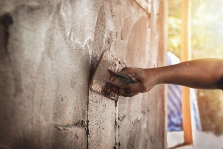 mason rural thailand Plastering concrete to build wall background industrial worker with plastering tools renovating house concept quality    の写真素材