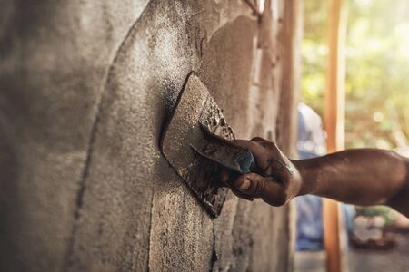 mason rural thailand Plastering concrete to build wall background industrial worker with plastering tools renovating house concept quality    の写真素材