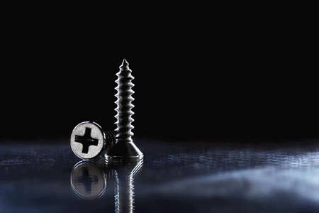 Scredws for attaching objects on black backgrounの写真素材