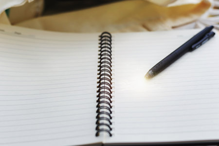 An empty notebook and a pen on the table.の写真素材