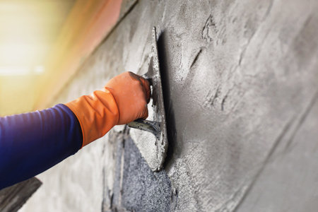 Concrete plasterers to create industrial workers background walls with plastering tools.の写真素材