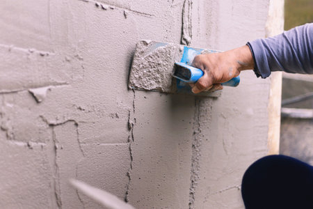 Concrete plasterers to create industrial workers background walls with plastering tools.の写真素材