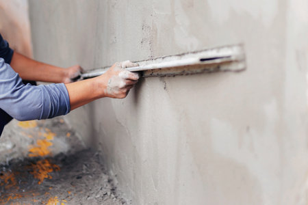 Concrete plasterers to create industrial workers background walls with plastering tools.の写真素材