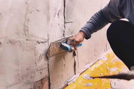 Concrete plasterers to create industrial workers background walls with plastering tools.の写真素材