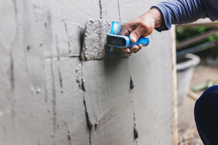 Concrete plasterers to create industrial workers background walls with plastering tools.の写真素材