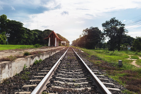 Rural train tracks with beautiful nature on both sides of the roadの写真素材