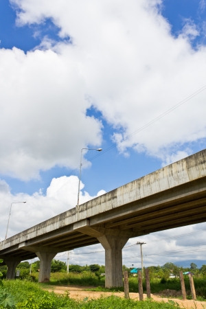 Non-Asphalt Road Under Bypass Road Leading to the City.の写真素材