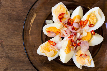 Boiled eggs with spicy Thai-style salad on the dish