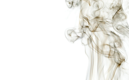 Abstract white smoke floating on dark backgroundの写真素材