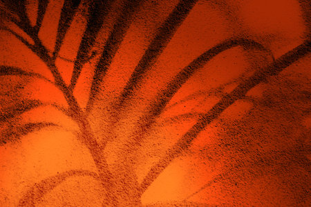 Palm tree shadow on rough and old concrete wall