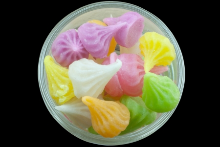 Colorful candy in a blow isolated in black backgroundの写真素材