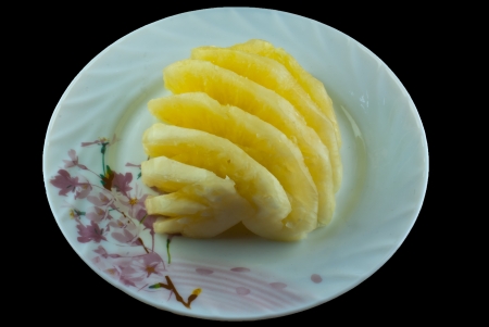 Ready to eat pineapple on black backgroundの写真素材