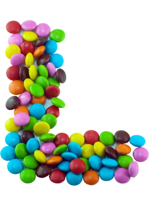 Colorful candies lay in letter  on white backgroundの写真素材