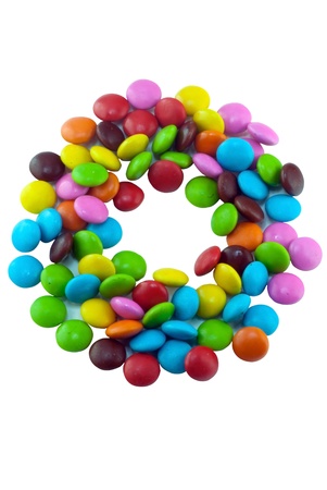 Colorful candies lay in letter O on white backgroundの写真素材