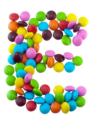 Colorful candies lay in letter E on white backgroundの写真素材