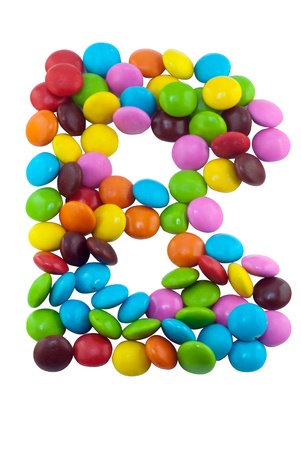Colorful candies lay in letter B in front of white backgroundの写真素材
