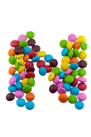 Colorful candies lay in letter N in front of white backgroundの写真素材
